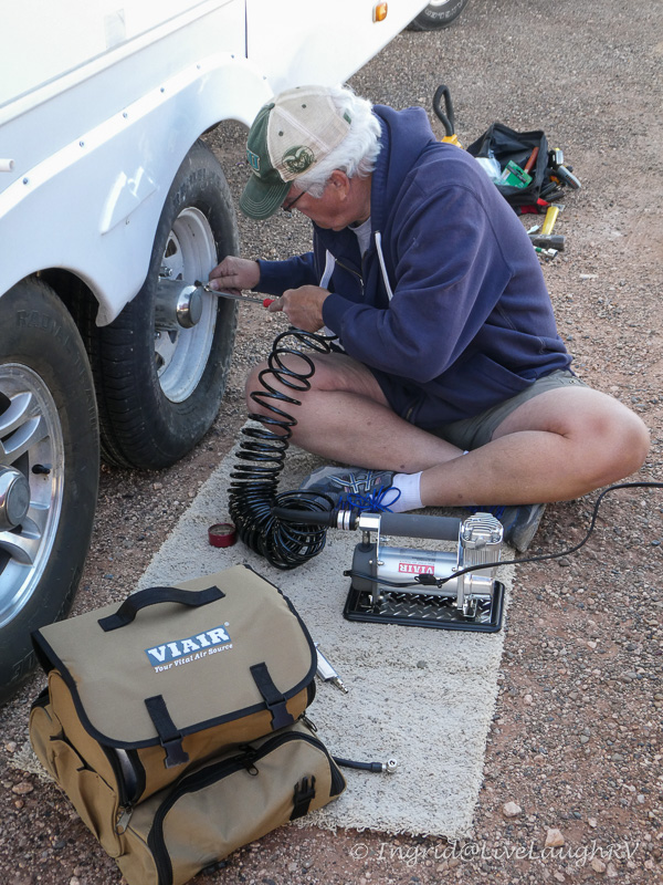 using a mobile air compressor after changing a flat tire on the RV