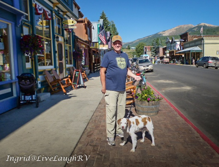 best dog friendly mountain towns, man walks do in downtown Crested Butte, #dog-friendly Colorado towns