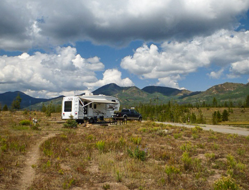 RV camped at Steamboat Springs with mountains in the background