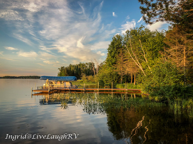 Reflections in a lake in northern Wisconsin, boat at a dock on a lake