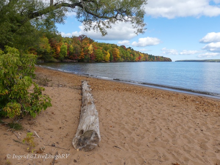 A beach along Lake Superior with fall colors